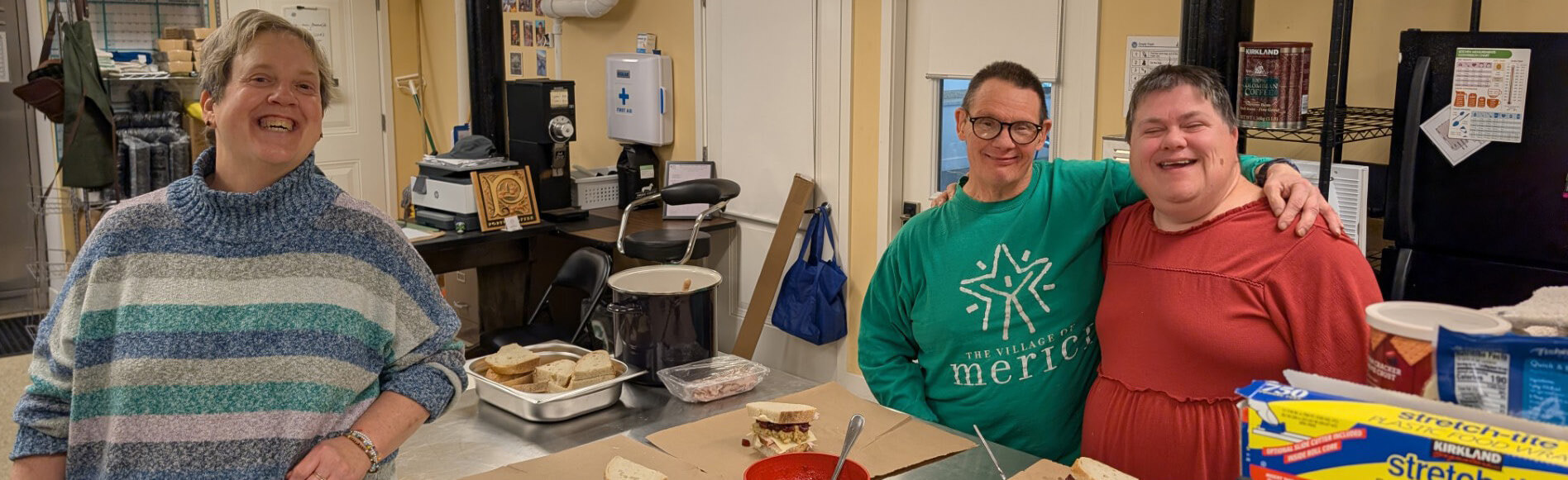 Participants preparing food together at a Merici Kitchen class
