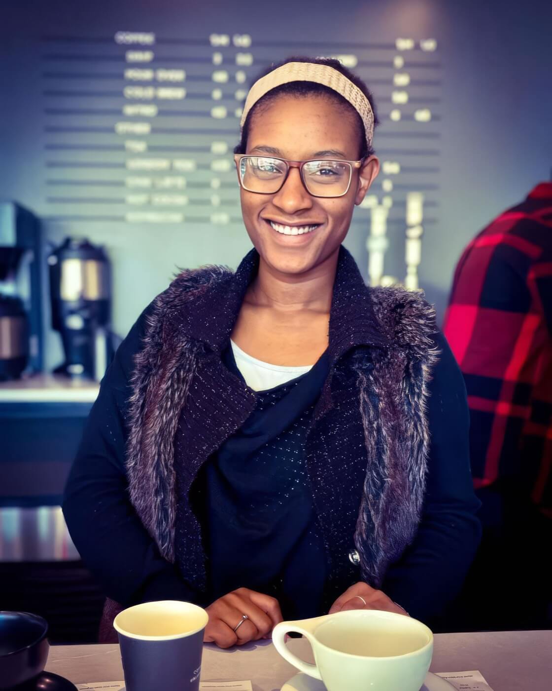 A Village of Merici resident smiling at a neighborhood coffee shop