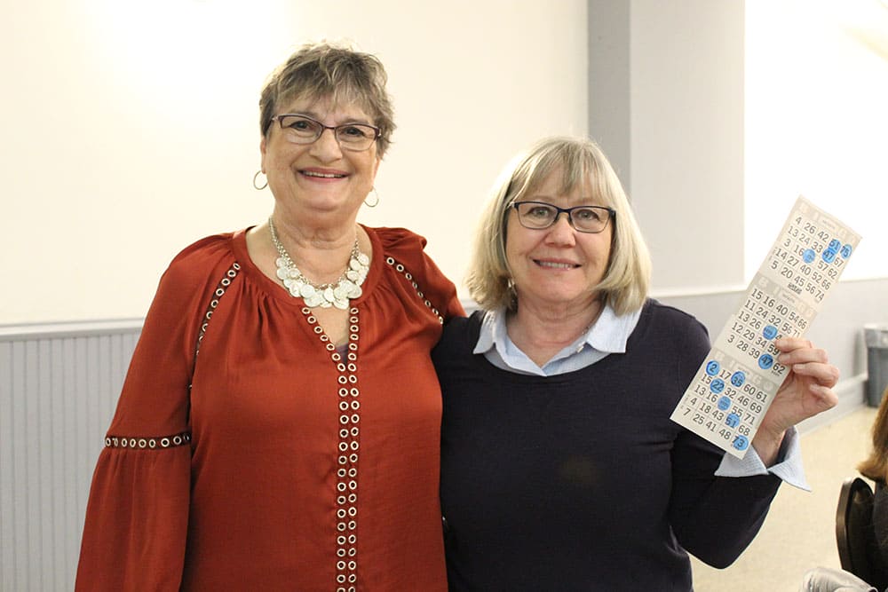 Two guests with their bingo cards