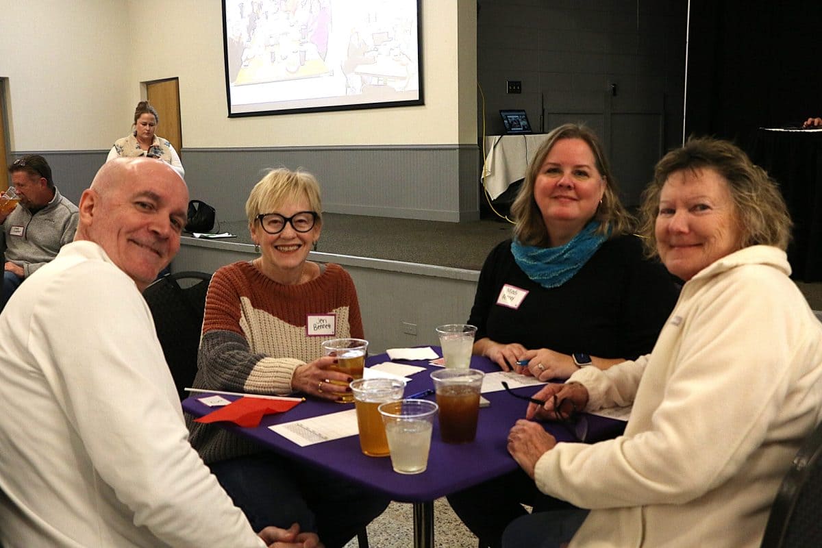 Four players at a card table at the Euchre Tournament