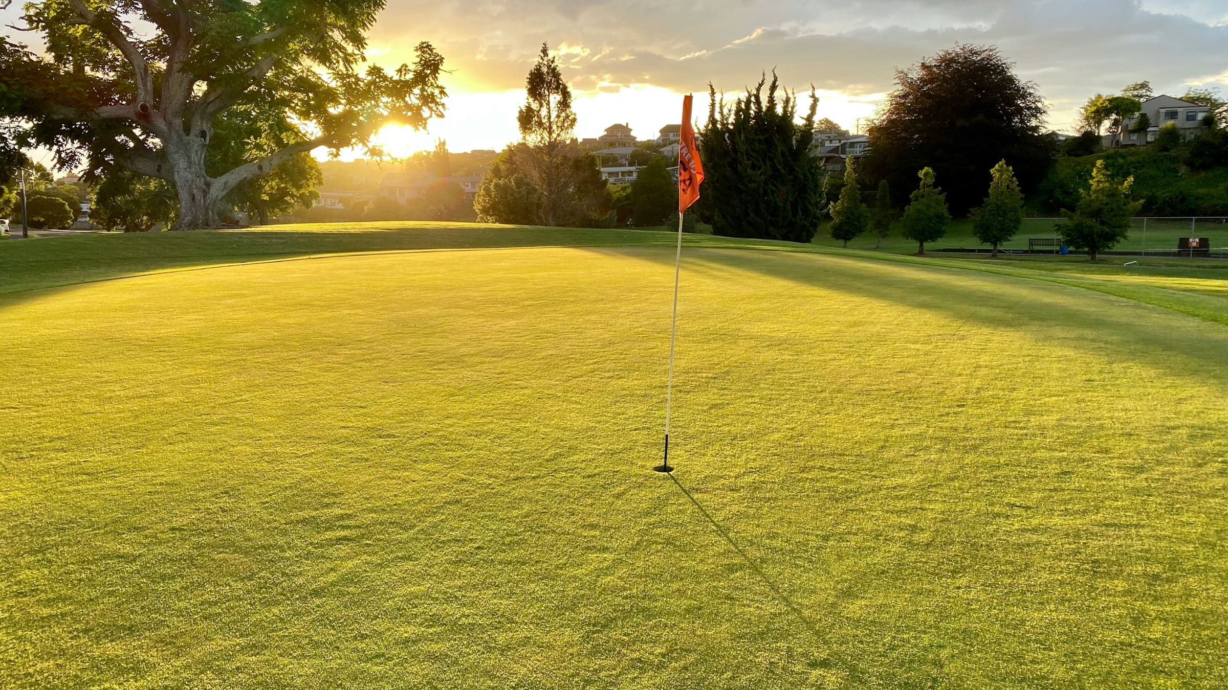 special-event-golf-hero A golf green and flag at sunrise