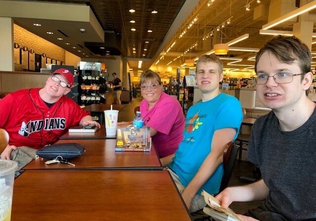 Members of a Village of Merici Book Club gathered around a table