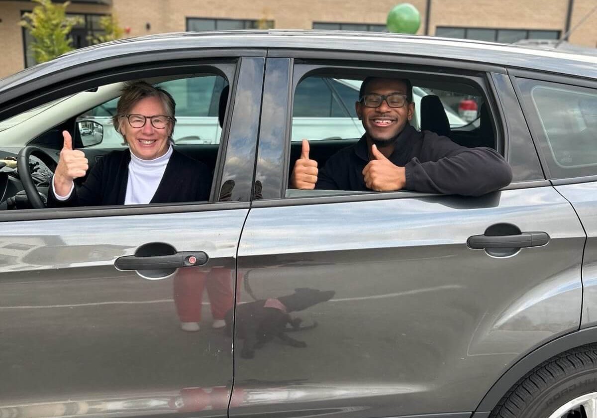 A volunteer driver and rider on a Merici City Rides trip
