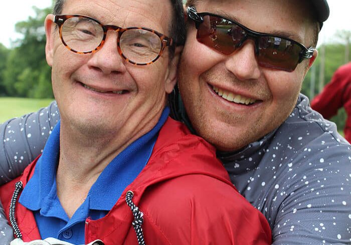Two friends at a Village of Merici golf outing
